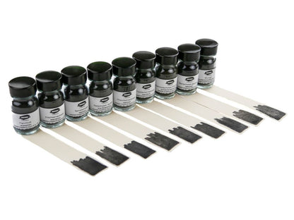Set of small bottles with black caps and labels, each containing a strip of black color swatch.