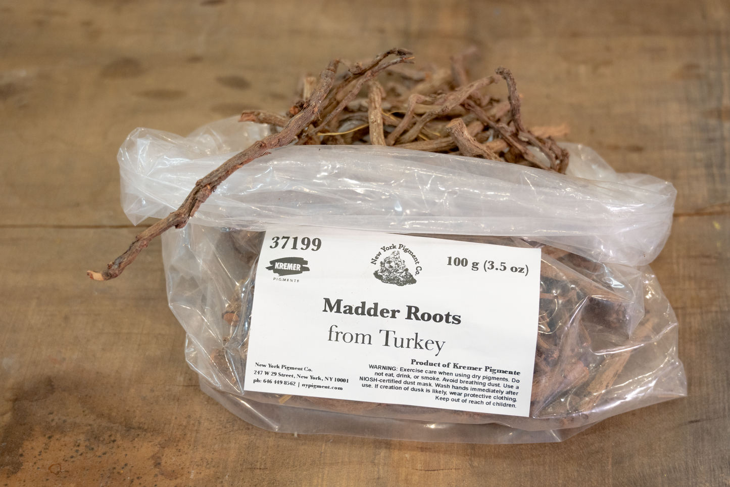 Bag of Madder Roots from Turkey on a wooden surface with a label.